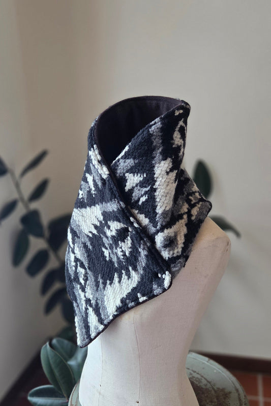 Black and white patterned wool snap cowls on a plain mannequin.